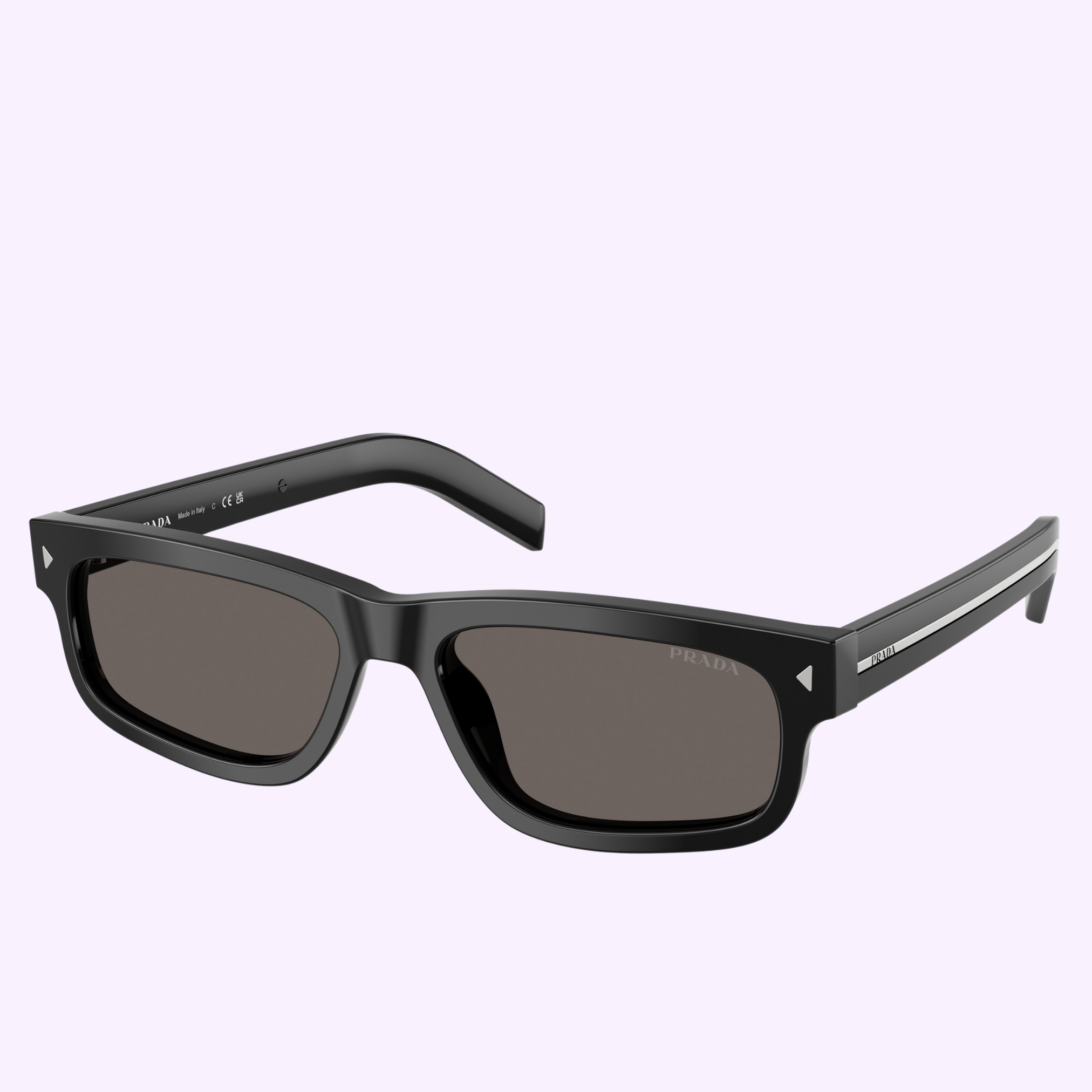 The PRADA Sunglasses 0PR B11SF 16K73157 feature black rectangular frames with dark lenses, a silver logo on the temples, a horizontal silver detail near the hinge, and sporty Prada Linea Rossa style. The background is pale lavender.
