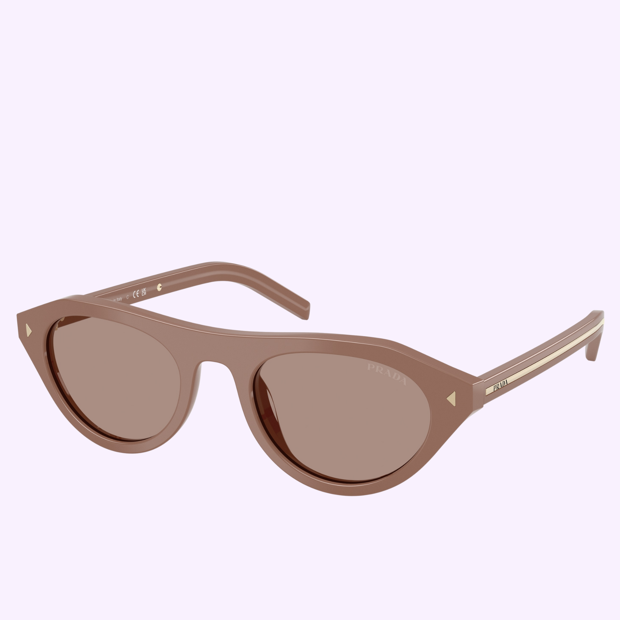 Light brown PRADA Sunglasses 0PR B15S 28D02T51 with tinted, subtly mask-shaped lenses and gold-accented temples, displayed against a plain light lavender background.