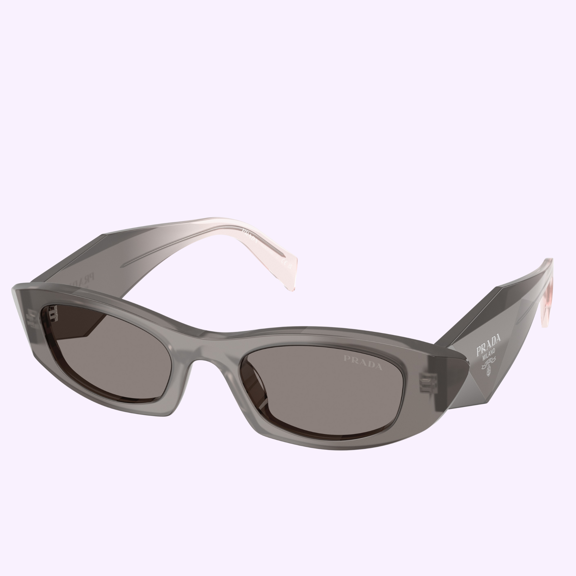 Prada Sunglasses 0PR B16S 20F80Q50 feature thick, translucent gray frames and dark tinted lenses with the PRADA logo on the temple, shown against a light purple background for a sporty look.