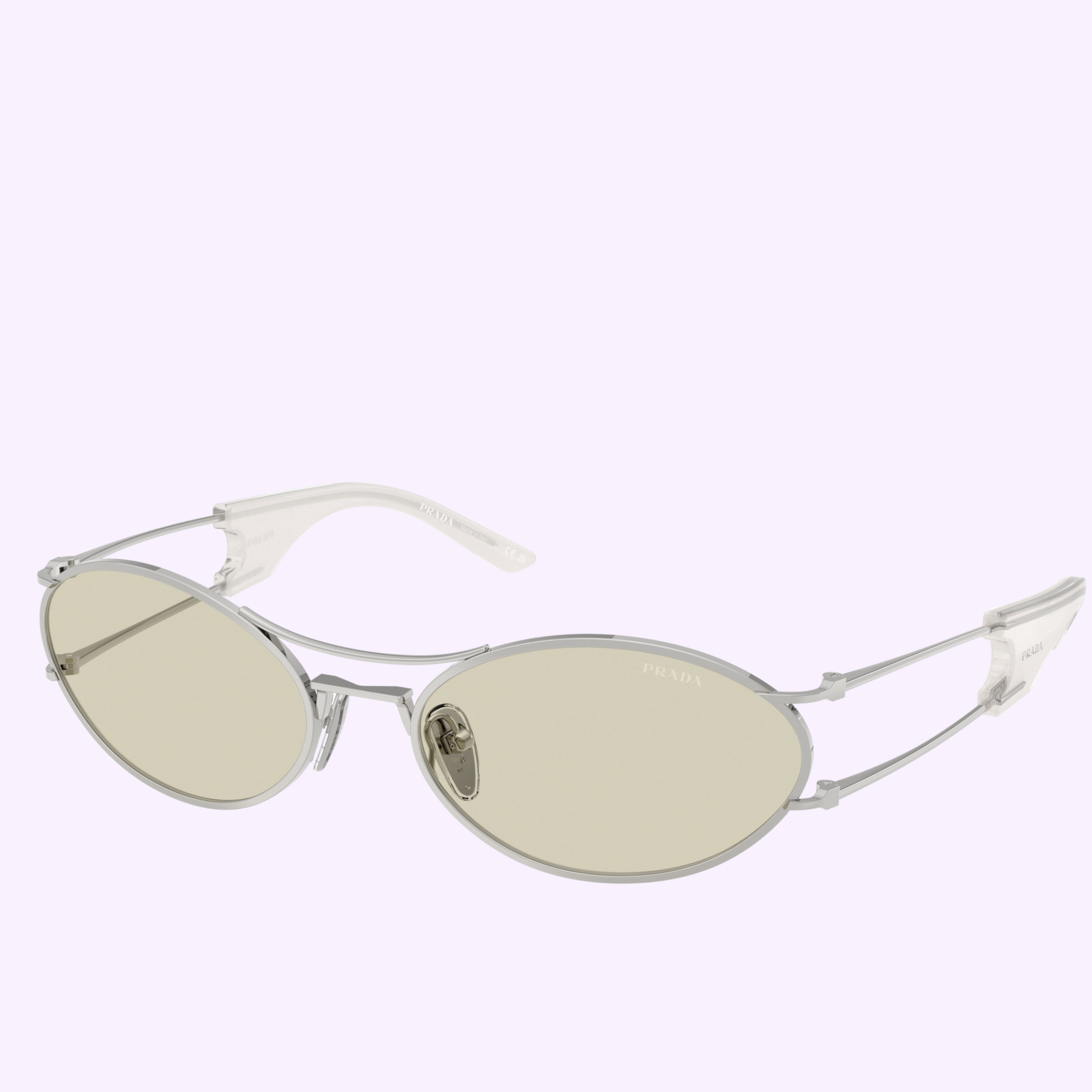 The PRADA Sunglasses 0PR D61S 1BC41B58 feature oval-shaped thin silver metal frames, light yellow-tinted lenses, and clear plastic temple tips, exuding subtle sophistication characteristic of Prada Sunglasses, shown against a plain light background.