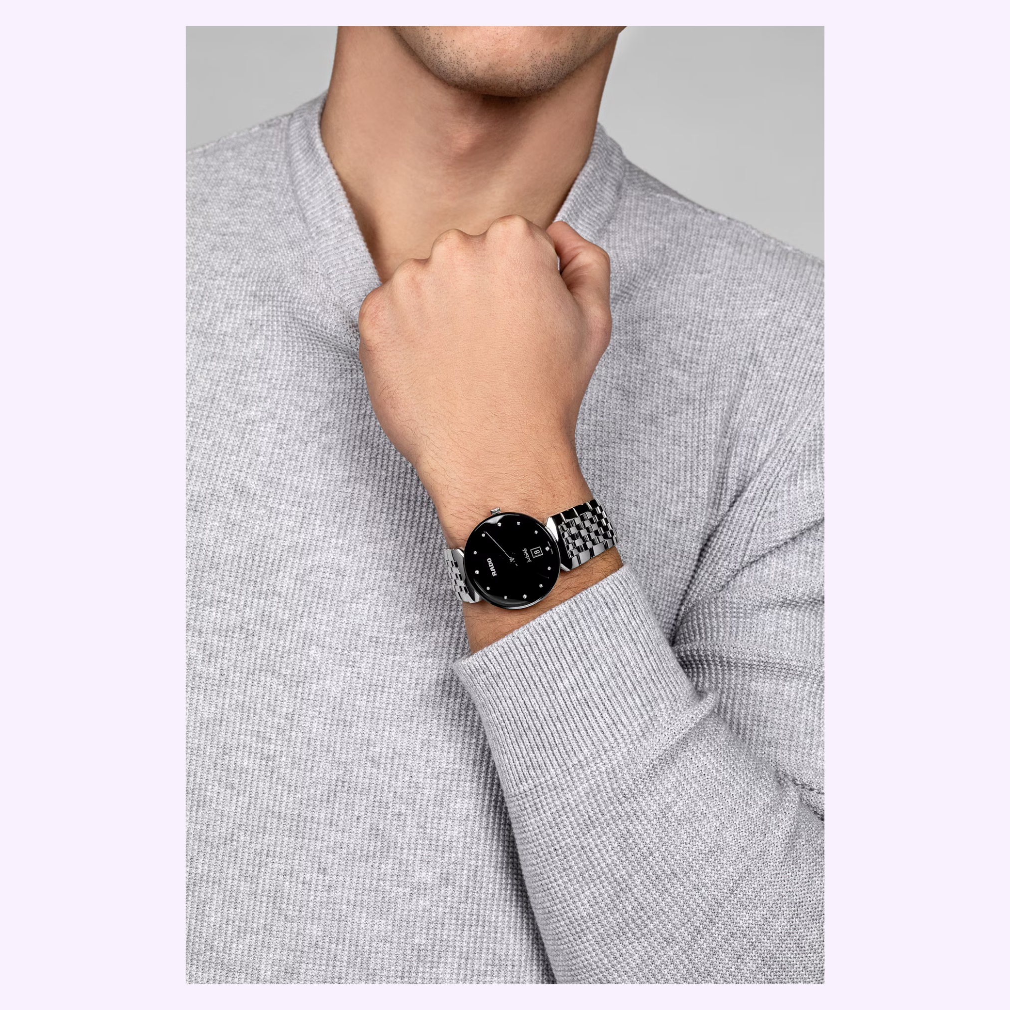 A person in a light gray sweater showcases a Rado Watches Florence Diamonds R48912733 on their left wrist, raising their hand near their chin.