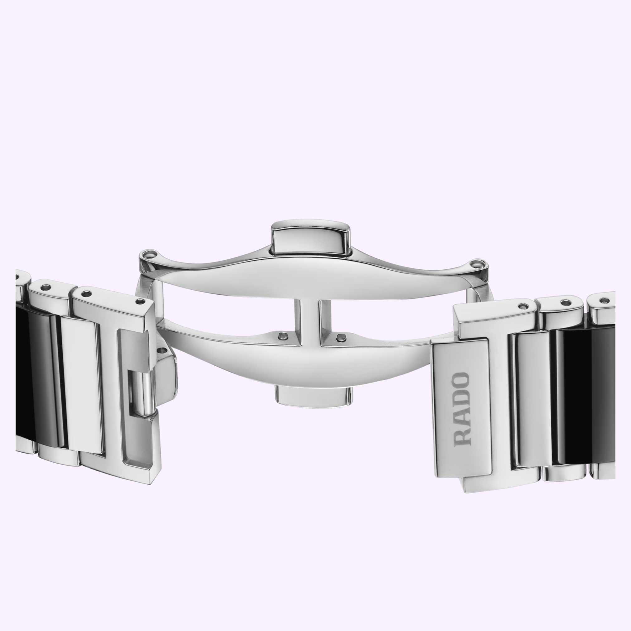 Close-up of the Rado Watches Integral Diamonds R20255712 bracelet clasp, showcasing a polished silver butterfly deployant buckle with black ceramic and stainless steel links, set against a light lavender background.