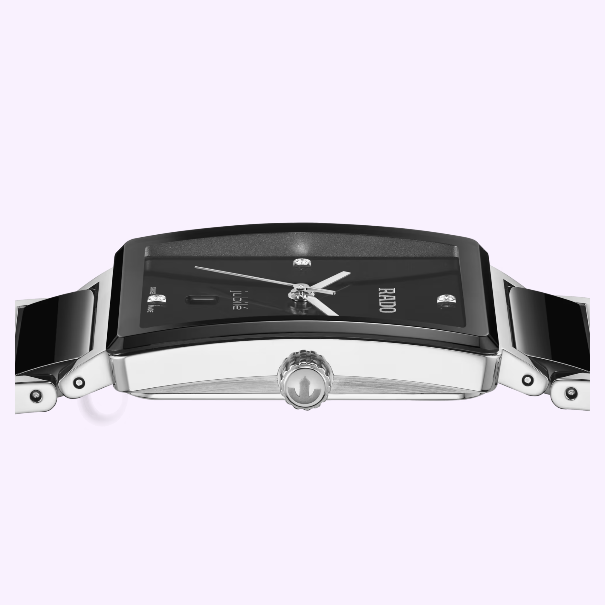 A close-up side view of the Rado Watches Integral Diamonds R20255712, featuring a black rectangular dial, silver hands, and a metal and black ceramic strap, set against a light purple background.