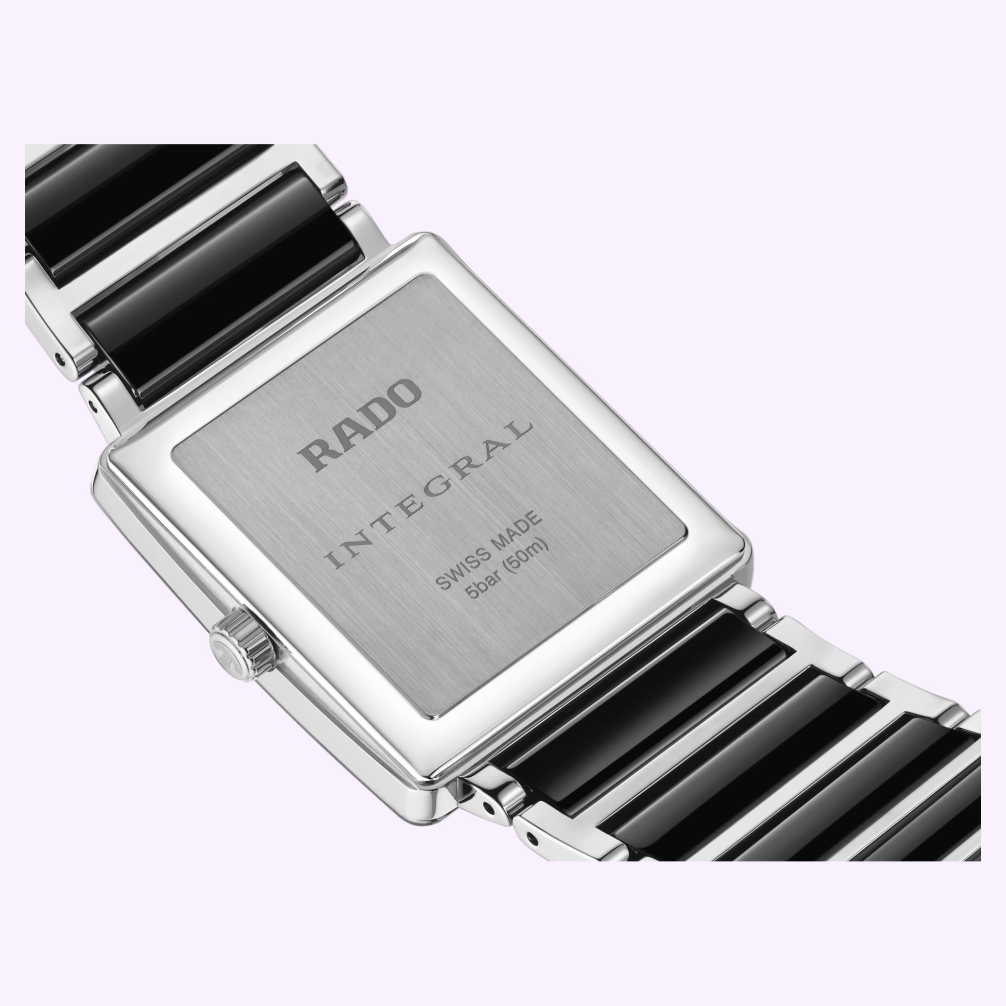Close-up of the Rado Watches Integral Diamonds R20255712's back, featuring a rectangular stainless steel case, black and silver bracelet, and engraved details of brand, model, Swiss made, water resistance on this Swiss quartz watch.