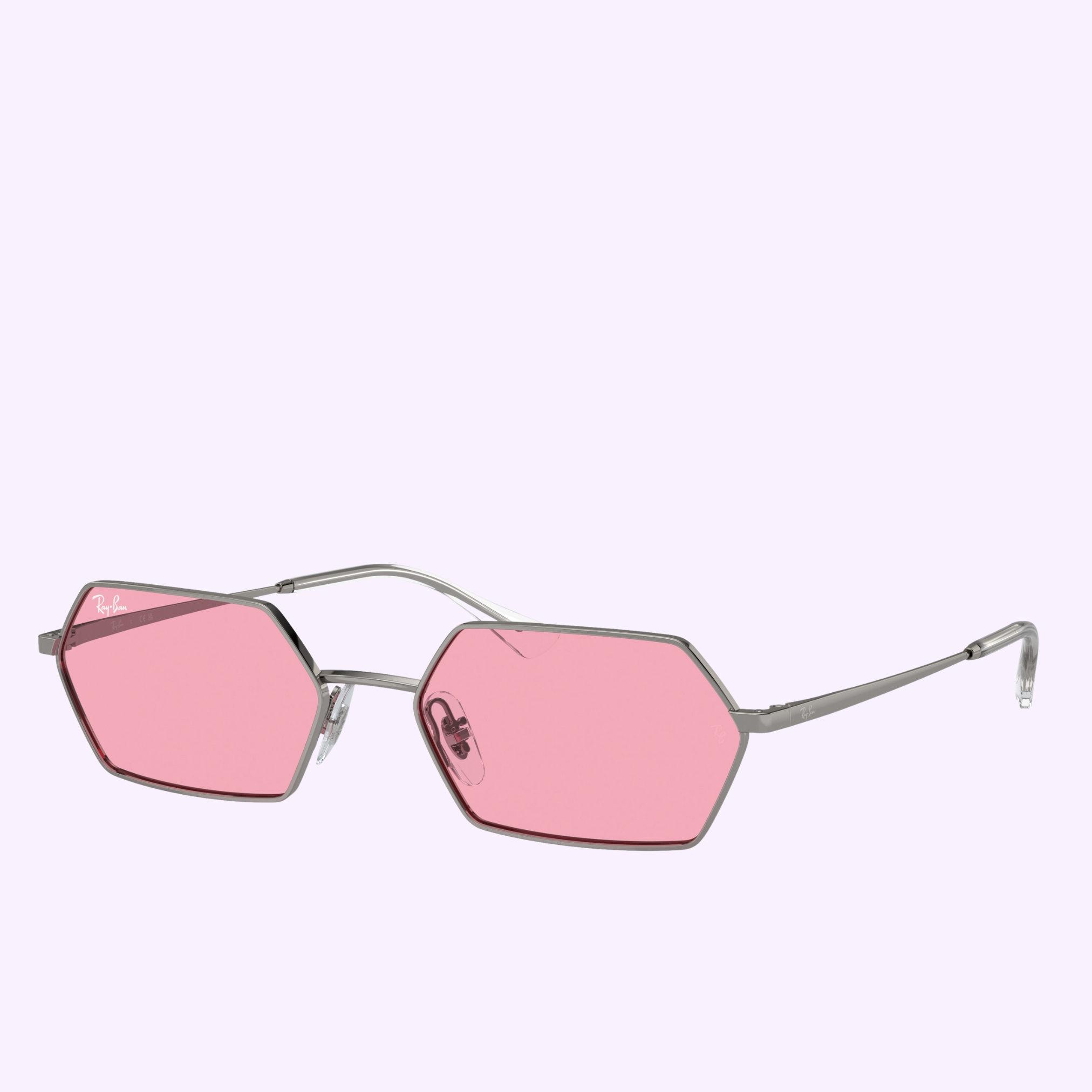 Ray-Ban Sunglasses 0RB3728 004/8458, featuring geometric hexagonal frames in silver metal and pink tinted lenses, are displayed on a light purple background.