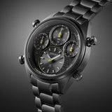 A close-up of the Seiko Watches Chronograph Solar SFJ007 by Seiko Watches, featuring a black metal band and case, three subdials, yellow-accented hands, and a textured face set against a gradient gray background.