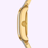 Side view of the Tory Burch Watches THE ELEANOR TBW1066 for women, showcasing a gold round case with the signature logo on the crown and reliable quartz movement, set against a light purple background.