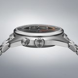 Side view of the Seiko Luxe Watches PROSPEX SPEEDTIMER MECHANICAL SPB515, featuring a silver metal band, two crowns, and a round domed glass face with orange and white details on a gradient gray dial.