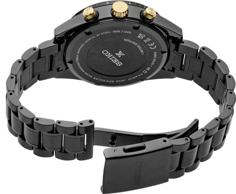 Close-up of the Seiko Speedtimer SSH169 black coated bracelet, gold-tone crown and pushers, engraved caseback and open three-fold clasp