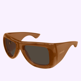 Saint Laurent Sunglasses SL 902 HOWL-017 63 feature bold, brown oversized frames with dark lenses, showcased at an angle on a light background—demonstrating the luxury and distinctive style synonymous with Saint Laurent Sunglasses.