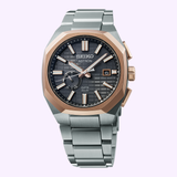 The Seiko King Watches Astron GPS SOLAR SSJ014 by Seiko Luxe Watches has a silver band, black textured dial, rose gold bezel and markers, date display, and luminescent hands and indices.