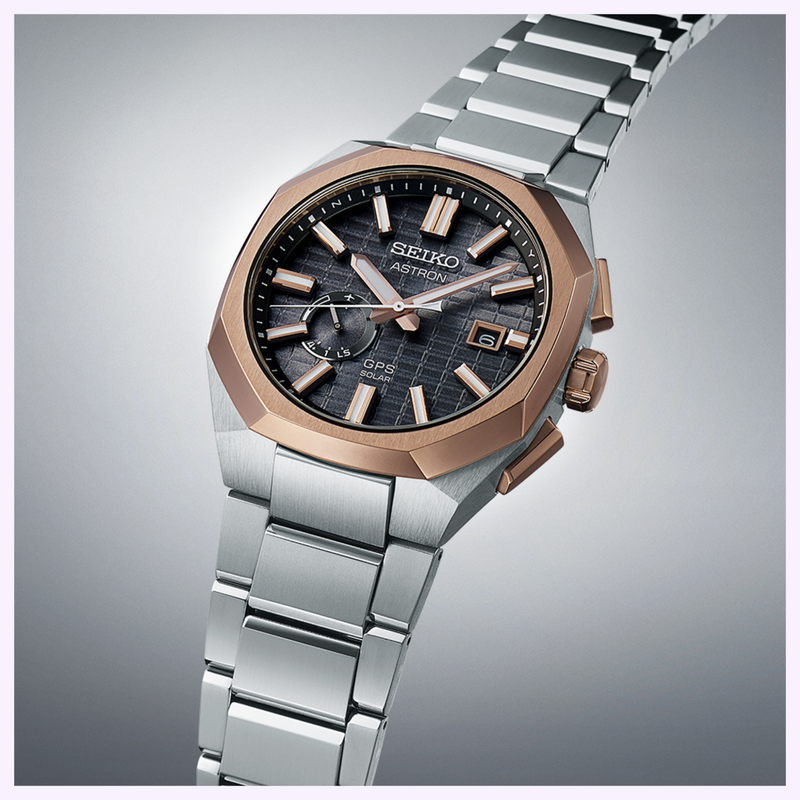 Seiko Astron SSJ014 Rose Gold-Tone Bezel Detail Seiko Astron SSJ014 with rose gold-tone octagonal bezel, textured dial and date display on titanium bracelet