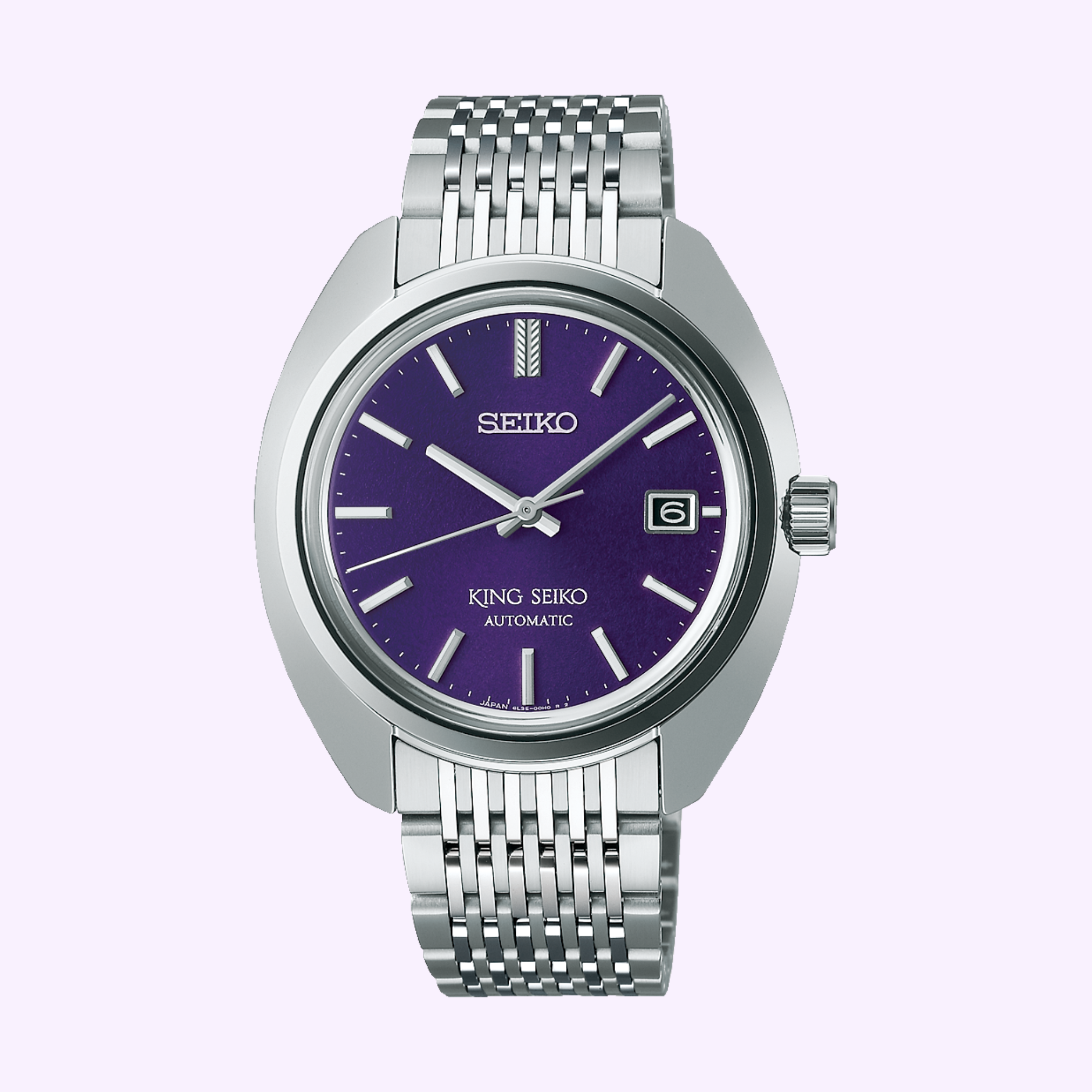 The Seiko Luxe Watches King SJE111 features a silver metallic bracelet, purple dial, silver hour markers and hands, a date window at 3 o’clock, and “King Seiko Automatic” above 6 o’clock. Part of the premium Seiko King Collection.