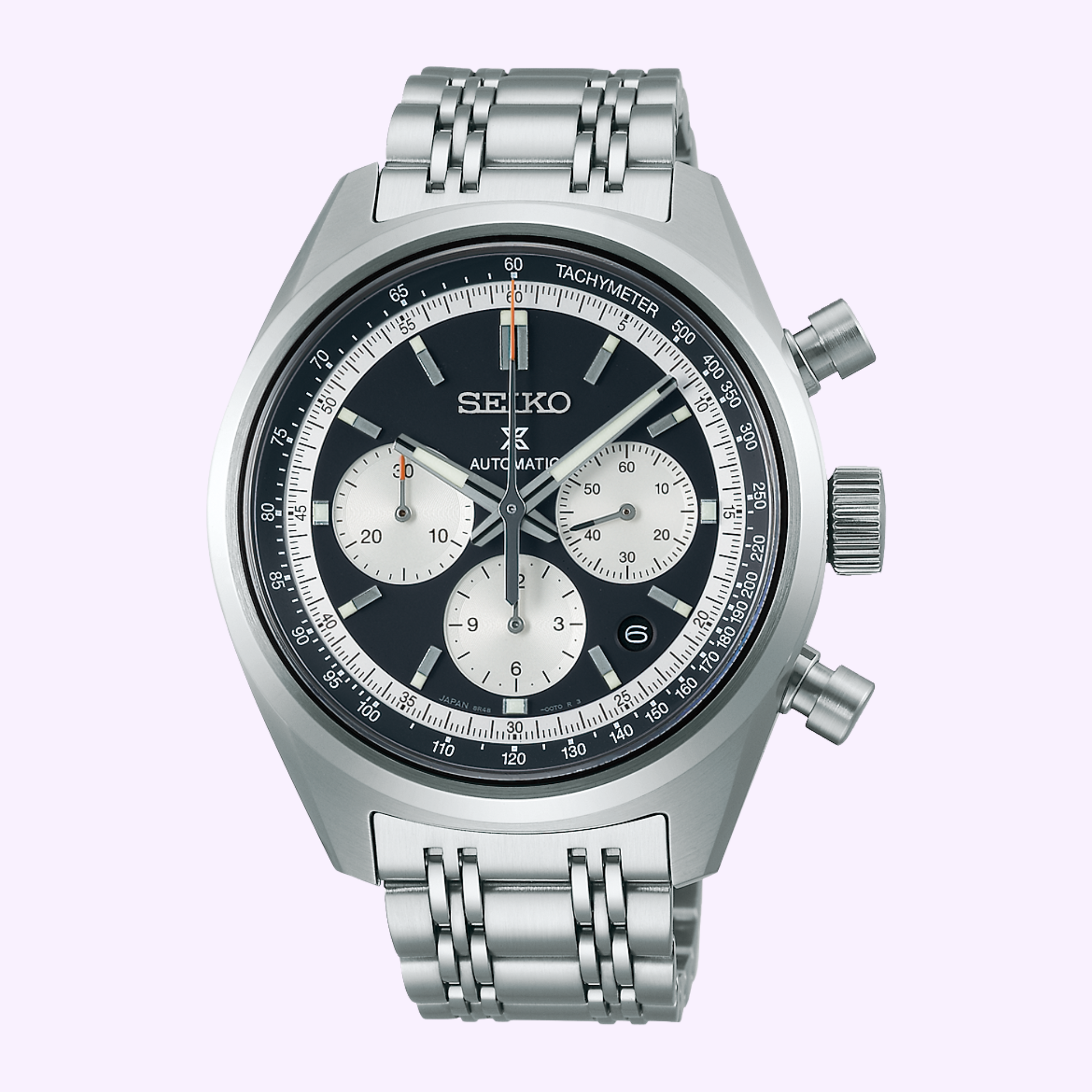 The Seiko Luxe Watches 100th Anniversary Prospex Speedtimer Mechanical Chronograph SRQ049 LIMITED EDITION features a silver case, black bezel, three subdials, tachymeter markings, and a metal link bracelet, shown on a light purple background.