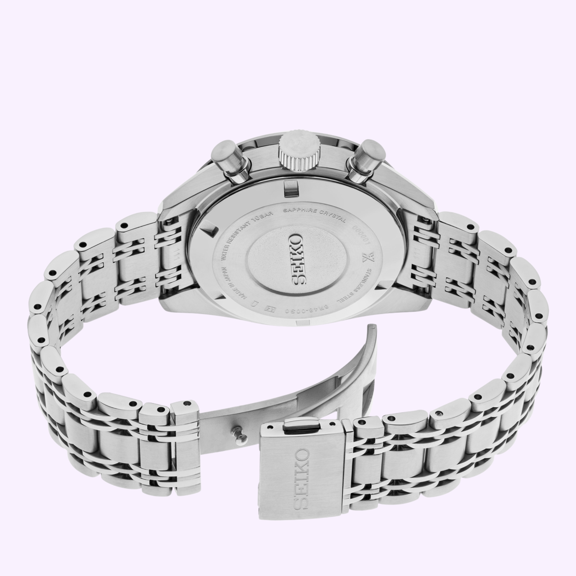 The Seiko Luxe Watches 100th Anniversary Prospex Speedtimer Mechanical Chronograph SRQ049 LIMITED EDITION is shown from the back, highlighting its closed caseback, metal link bracelet, and Seiko-branded clasp on a light purple background.