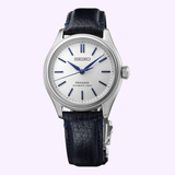 The Seiko Luxe Watches Presage Classic Series HCC004 Limited Edition features a silver dial with blue markers and hands, black textured leather strap, polished stainless steel case, and “SEIKO” with “PRESAGE AUTOMATIC 3 DAYS” on the face.