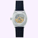 The Seiko Luxe Watches Presage Classic Series HCC004 Limited Edition features a see-through case back displaying its automatic movement and gold rotor, a dark blue leather strap, and "Limited Edition" engraved on the back.