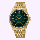 A gold Seiko Luxe Watches Presage Classic Series HCC009 Limited Edition wristwatch with a green face, gold hour markers, and a metal link band. Showcasing Japanese craftsmanship, the Seiko Luxe Watches Presage Classic Series HCC009 features the words Seiko, Presage, and Automatic 3 Days on its watch face.