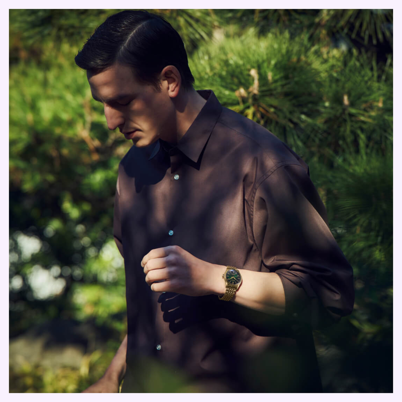 Man wearing a brown button-up shirt and the gold Seiko Presage HCC009 Limited Edition outdoors