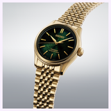 A Seiko Luxe Watches Presage Classic Series HCC009 Limited Edition wristwatch with a gold case, green textured dial, gold hour markers, and a metal link bracelet is showcased on a light gray gradient background, highlighting Seiko Luxe Watches’ renowned Japanese craftsmanship and precise automatic movement.