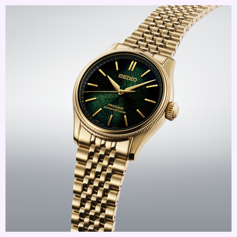 Seiko Presage HCC009 Limited Edition wristwatch with gold case, green textured dial, and metal link bracelet on a gray gradient background