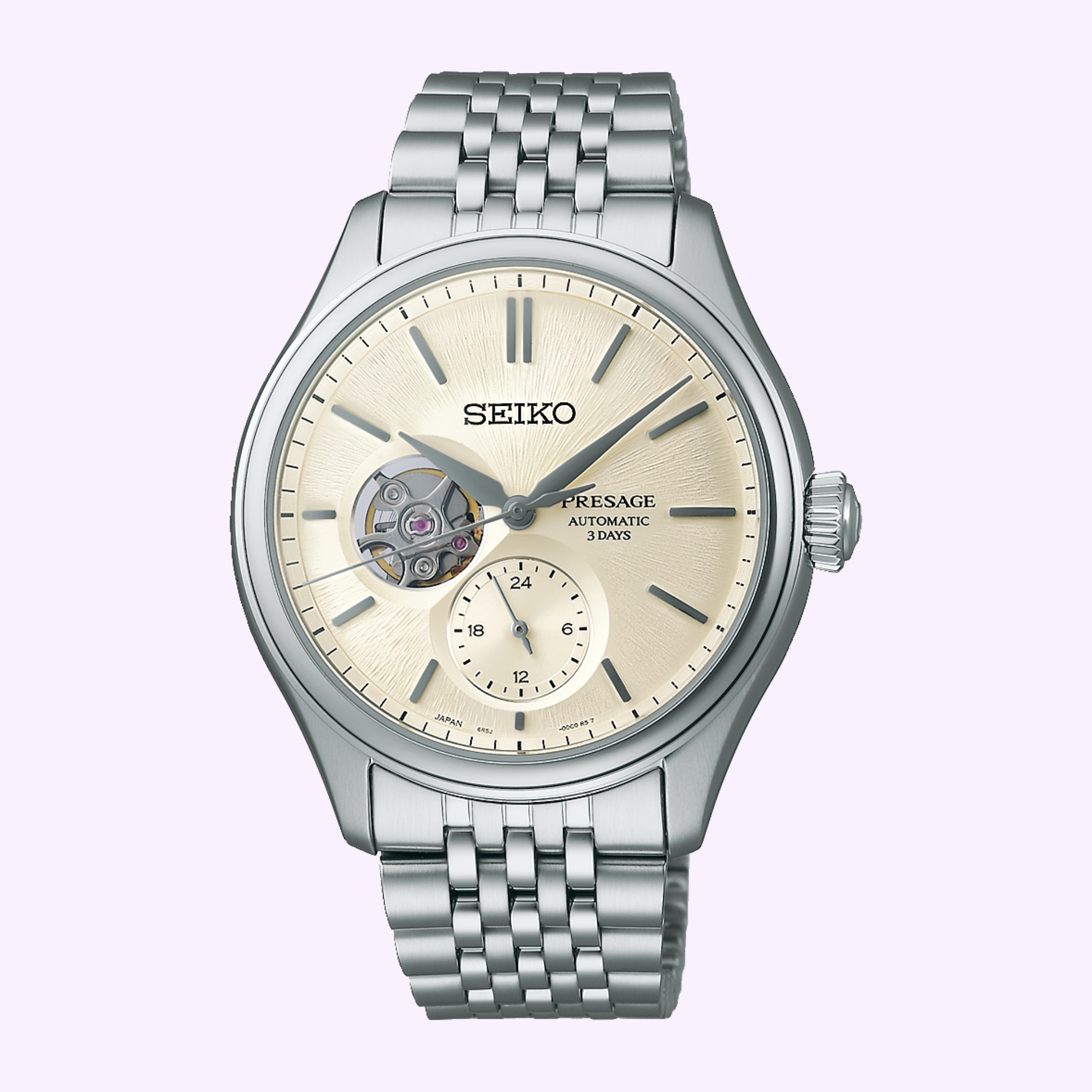 The Seiko Luxe Watches Presage Classic Series SPB469 features a silver case, cream dial with open-heart and small seconds subdial at 6 o’clock, plus a metal link bracelet, highlighting refined Japanese craftsmanship on a light purple background.