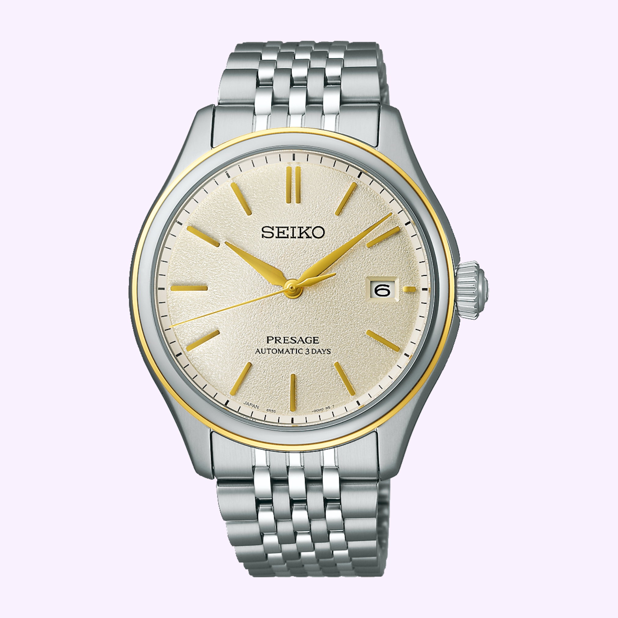 The Seiko Luxe Watches Presage Classic Series SPB478 features a silver case, cream dial with gold accents, automatic movement, date at 3 o’clock, and a silver link bracelet, shown against a light purple background.