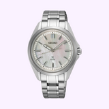 The Seiko Watches Prospex Sea SUR605 features a stainless steel bracelet, light mother-of-pearl dial, silver hour markers, and three hands, shown against a pale lavender background.