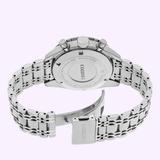 A Seiko Luxe Watches Prospex Speedtimer Mechanical Chronograph SRQ047 is shown from the back, highlighting its engraved case back, two pushers, crown, and open clasp on the metal bracelet against a light purple background.