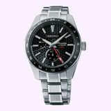 The Seiko Luxe Watches PRESAGE SHARP-EDGED SERIES GMT SPB221 features a stainless steel band, black patterned dial, white markers, date subdial, and red-tipped GMT hand—showcasing Japanese craftsmanship.