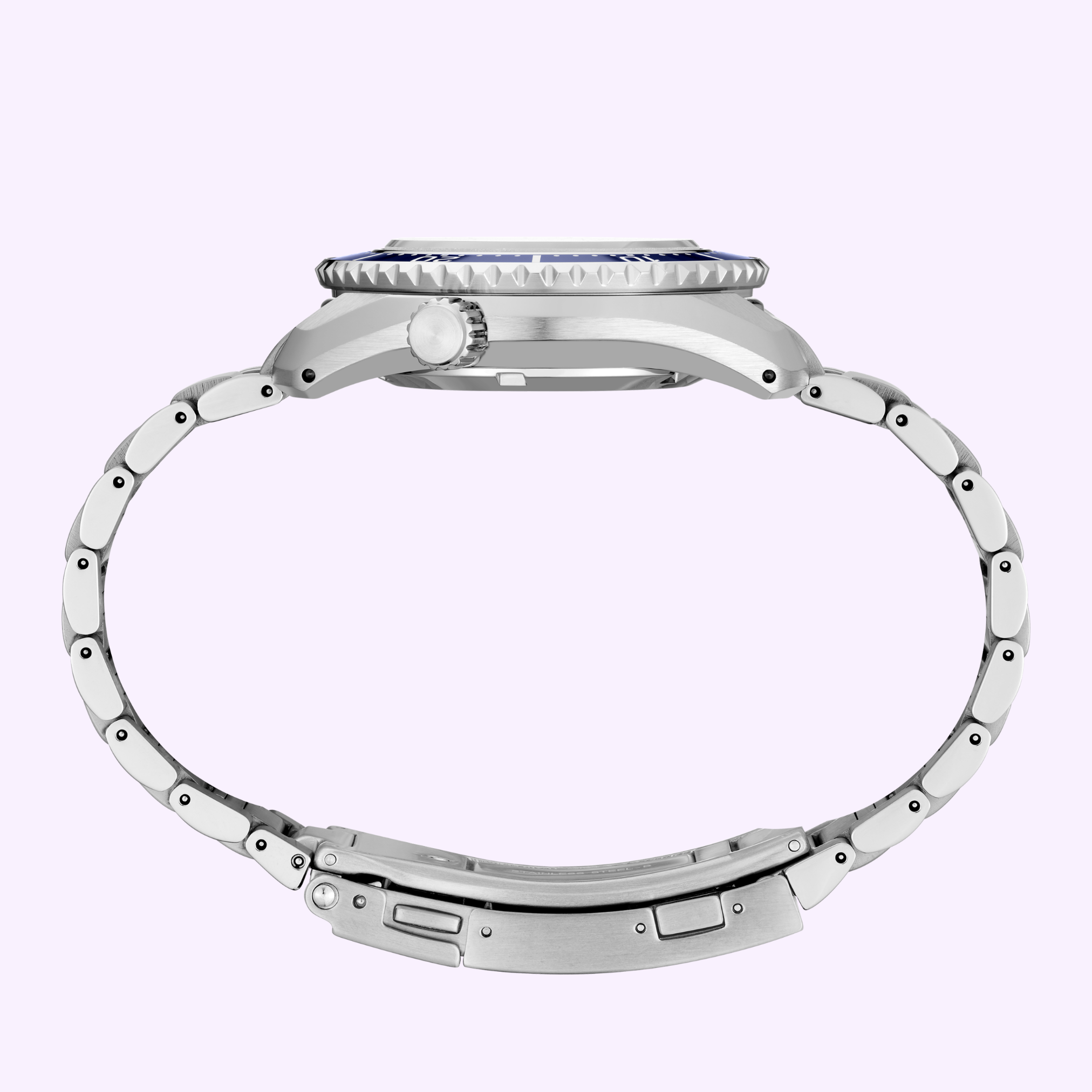Side view of a silver Seiko Luxe Watches SPB519 PROSPEX HERITAGE DIVER'S GMT with round case, crown, and linked bracelet, set against a pale lavender background.