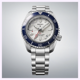 The Seiko Luxe Watches SPB519 PROSPEX HERITAGE DIVER'S GMT has a stainless steel case, white dial, blue bezel, silver markers, red GMT hand, “GMT AUTOMATIC 3 DAYS DIVERS 300m” text, and a linked metal bracelet.