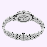The Seiko Luxe Watches SSK037 Presage Cocktail Time is displayed from the back, showcasing its exhibition case back and mechanical movement. Its stainless steel bracelet is fully extended, set against a light background.