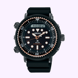 The Seiko Prospex Men Watches SNJ028 by Seiko Watches is a solar-powered diver watch with a black dial, top digital display, bold white markers, black rubber strap, and 200m water resistance.