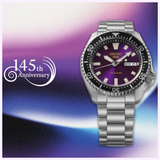 A Seiko Watches 5 Sports HDB003 145th Anniversary Limited Edition automatic watch, featuring a striking purple dial and a sleek silver bracelet, is displayed. Beside it, the text “145th Anniversary” appears on a purple and white gradient background.