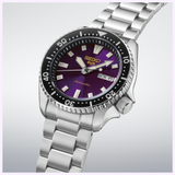 A Seiko Watches 5 Sports HDB003 145th Anniversary Limited Edition wristwatch by Seiko Watches, featuring a silver metallic strap, black bezel, and a purple dial with luminous hands and hour markers. The day-date display is set to MON 6.