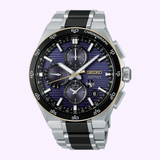 A Seiko Watches Astron HAB011J1 145th Anniversary Limited Edition chronograph wristwatch by Seiko Watches, featuring a black and silver band, striking purple dial with three subdials, date display, and labeled buttons, set against a light background.