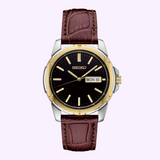 The Seiko Watches Essentials SUR360 by Seiko Watches is a men’s quartz timepiece featuring a brown leather strap, an eye-catching black dial, a two-tone stainless steel gold and silver case, and a day-date window showing MON 6.