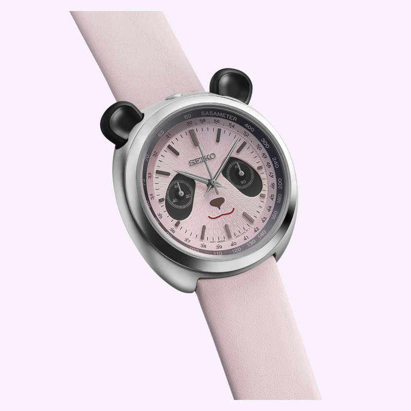 Close-up of the Seiko HHK002 pale pink panda face dial with black subdial eyes, bamboo-leaf hands and Sasameter tachymeter scale