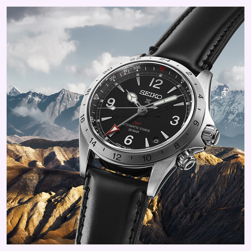Seiko Prospex Alpinist GMT SPB379 watch with black leather strap photographed against a snow-capped mountain landscape
