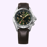 The Seiko Watches Prospex Alpinist HBC007 by Seiko Luxe Watches features a brown leather strap, a green dial with gold hands, a silver bezel marked with 24-hour indices, and precise quartz movement, displayed against a light background.