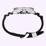 A side view of the Seiko Watches Prospex Automatic Diver SRPE37 wristwatch by Seiko Watches, featuring a silver case and a black curved strap that is unfastened and arranged in a wavy shape, displayed against a light purple background.