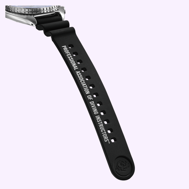 Close-up of the included PADI-branded silicone strap reading Professional Association of Diving Instructors