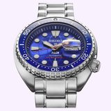 Introducing the Seiko Luxe Watches Prospex HBB002 Limited Edition, an automatic diver’s watch highlighted by its blue gradient dial, silver hour markers, and durable stainless steel bracelet. Powered by a dependable automatic mechanical movement, this limited edition dive watch features a day and date display positioned at 3 o’clock.
