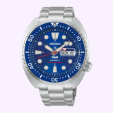 A Seiko Watches Prospex HBB002 Limited Edition dive watch from Seiko Luxe Watches, featuring a silver stainless steel band, a blue bezel, a blue dial with white hour markers, and a date display showing MON 6. This timepiece showcases an automatic mechanical movement inspired by Seiko’s renowned dive watch designs.