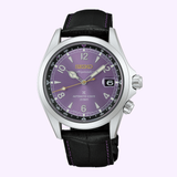The Seiko Watches Prospex HBC006 145th Anniversary Limited Edition showcases a captivating purple dial with silver markers and a black leather strap accented by purple stitching. A date window at 3 o’clock adds to its refined design, elegantly presented here against a light background.