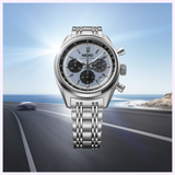Seiko Luxe Watches Prospex Speedtimer HBD001 chronograph wristwatch featuring a light blue textured dial, three black sub-dials, and a silver-tone metal link bracelet.