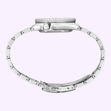 The Seiko Watches 5 Sports X Rowing Blazers SRPM21 Limited Edition by Seiko Watches is displayed from the side, showcasing its round case, crown, and metal link bracelet with a clasp against a light purple background.