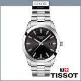 A Tissot T1274101105100 Gentleman men’s watch by Tissot Watches, featuring a silver metal link band and black dial, is displayed with the Tissot and Lexor Miami logos above and below on a white background.