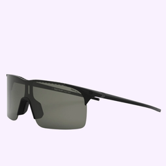 Tag Heuer Sunglasses TH40018I 0002A: sleek, black rimless shades with a single shield lens and minimalist design, set on a light purple background. 100% authentic and available from an authorized Miami dealer.
